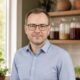 Serge, author of Slow Larder, in his kitchen with fermentation jars and microgreens