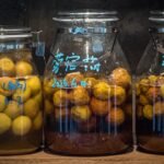 Three jars of preserved fruit with handwritten labels.
