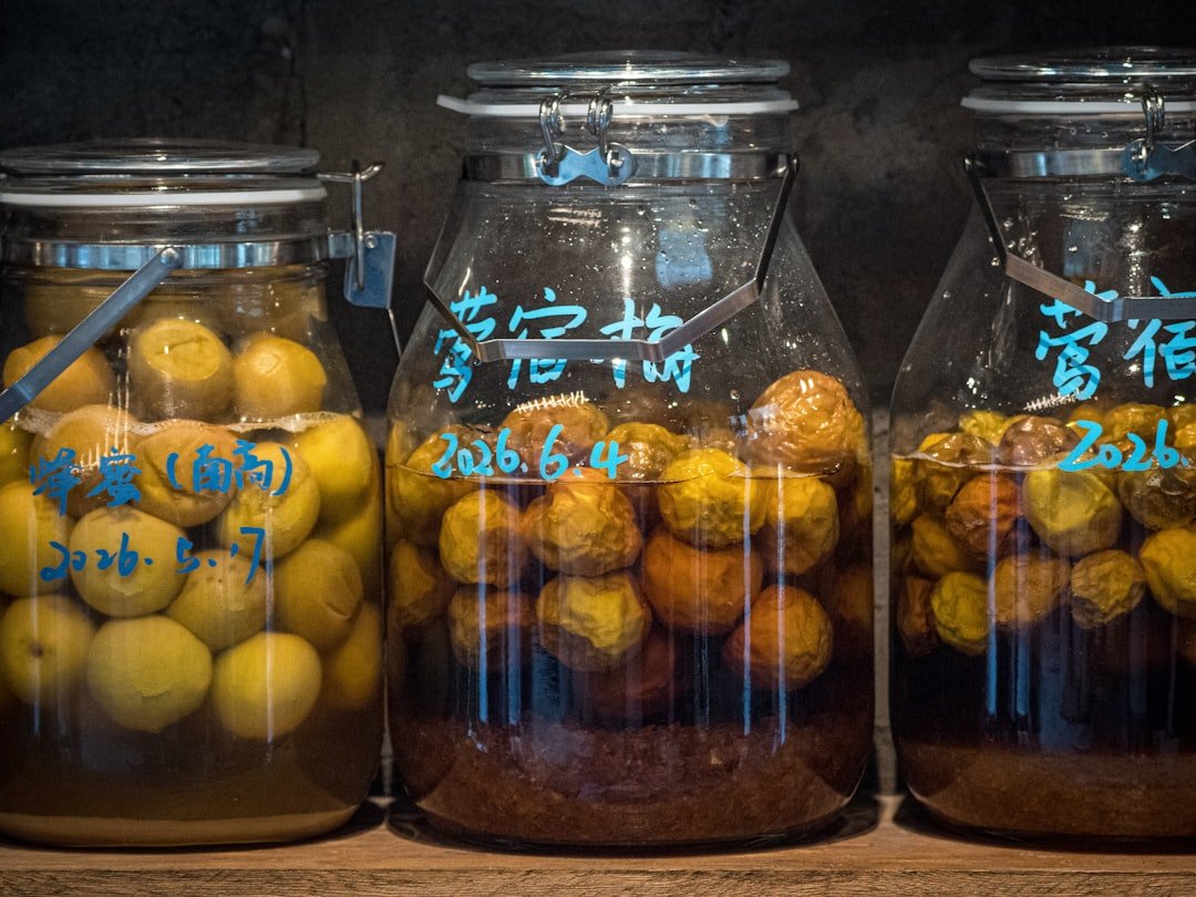 Three jars of preserved fruit with handwritten labels.